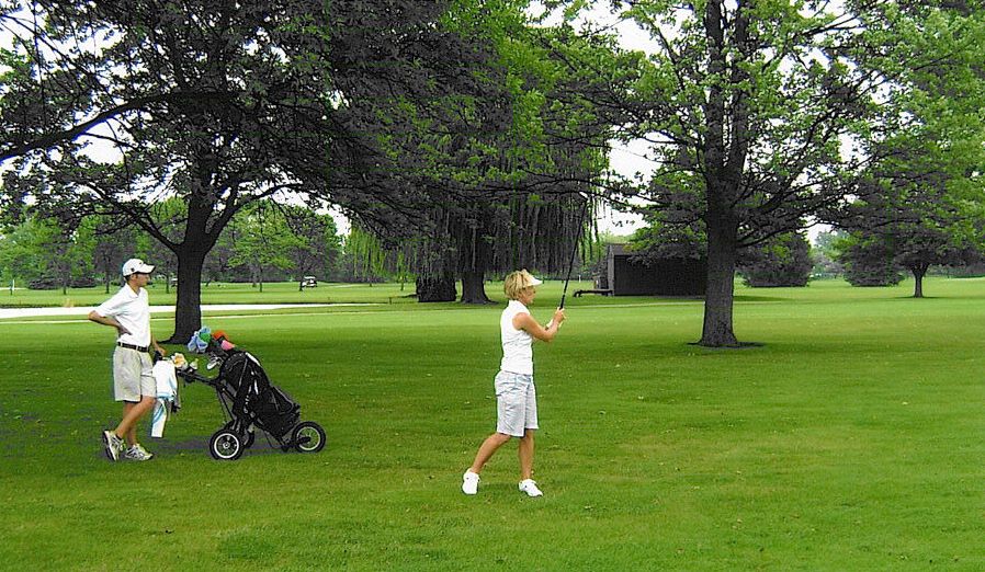  Julie Tabor watches her 2nd shot on #6 while her caddy (also her son Tyler) looks on. 